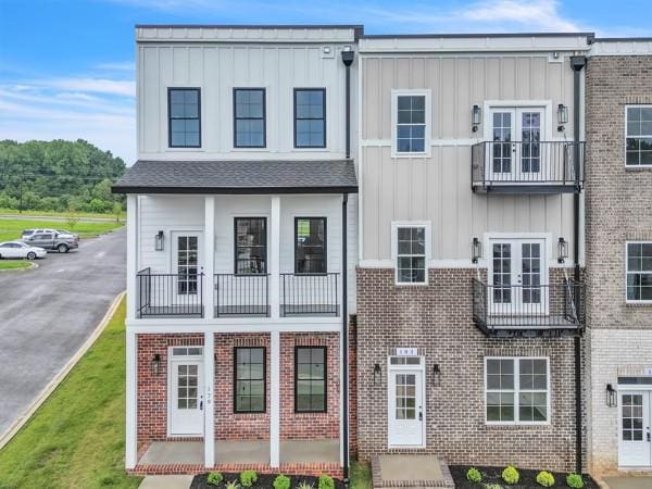 179 Charleston Ave, Pleasant View, TN 37146 - townhome / multi-family property featuring board and batten siding, french doors, and brick siding