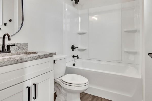 179 Charleston Ave, Pleasant View, TN 37146 - full bathroom with vanity, wood finished floors, and shower / bath combination