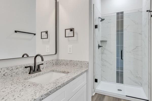 179 Charleston Ave, Pleasant View, TN 37146 - bathroom featuring a marble finish shower, vanity, and wood finished floors