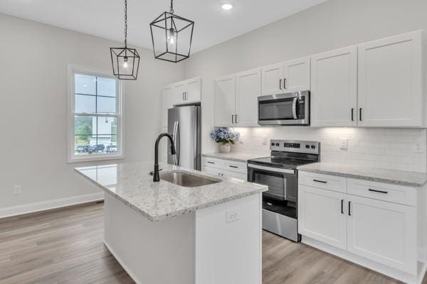 179 Charleston Ave, Pleasant View, TN 37146 - kitchen featuring stainless steel appliances, an island with sink, decorative backsplash, white cabinetry, and recessed lighting