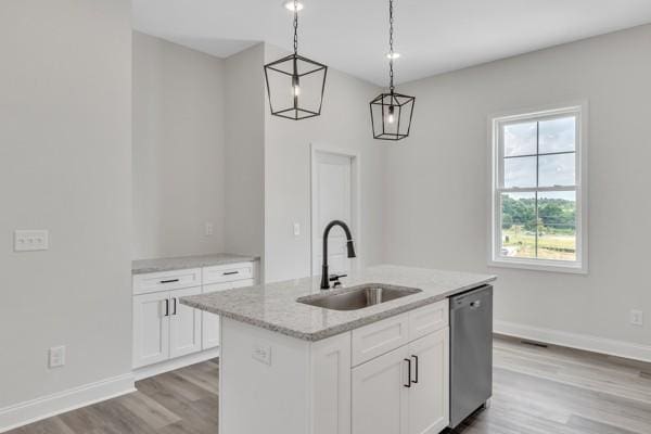 179 Charleston Ave, Pleasant View, TN 37146 - kitchen featuring stainless steel dishwasher, light wood-style flooring, light stone counters, and white cabinetry