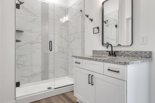 183 Charleston Ave, Pleasant View, TN 37146 - bathroom with a marble finish shower, vanity, and wood finished floors