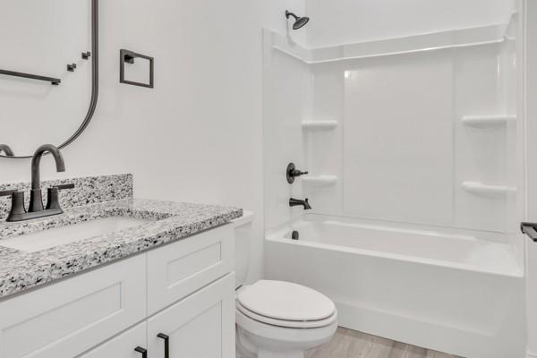 183 Charleston Ave, Pleasant View, TN 37146 - full bathroom featuring vanity, bathing tub / shower combination, and wood finished floors