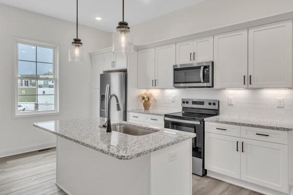 183 Charleston Ave, Pleasant View, TN 37146 - kitchen with appliances with stainless steel finishes, white cabinetry, light wood finished floors, tasteful backsplash, and recessed lighting