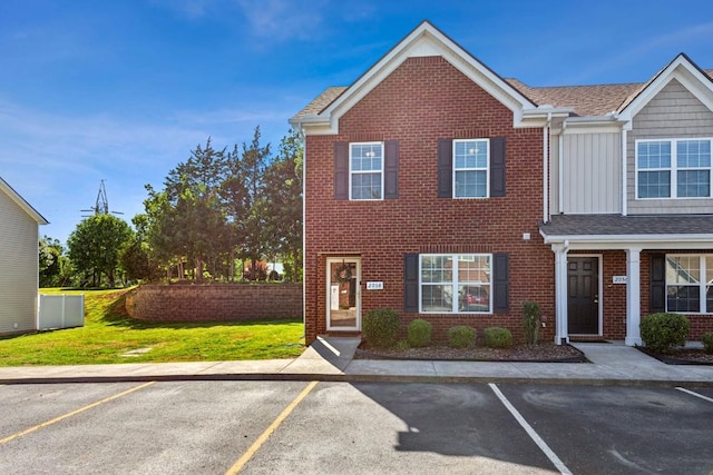 2058 Caladonia Way, Smyrna, TN 37167 - view of property with brick siding, uncovered parking, board and batten siding, and a front lawn