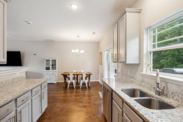 717 Monarchos Bnd, Burns, TN 37029 - kitchen featuring dishwasher, a chandelier, dark wood finished floors, decorative light fixtures, and light stone counters