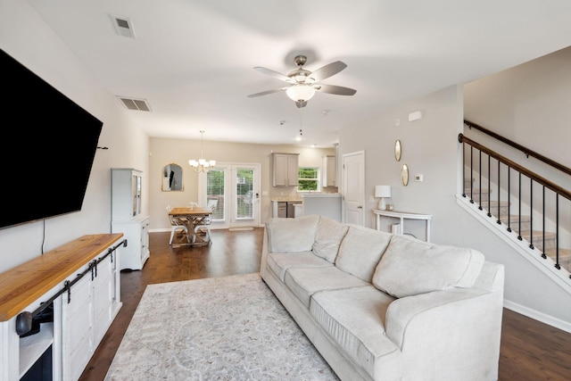 717 Monarchos Bnd, Burns, TN 37029 - living room with dark wood-style flooring, a ceiling fan, a chandelier, and stairs