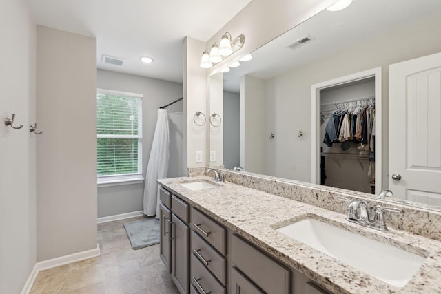 717 Monarchos Bnd, Burns, TN 37029 - bathroom with double vanity, a spacious closet, and recessed lighting