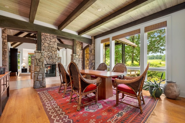 7909 Shoals Branch Rd, Primm Springs, TN 38476 - dining space with wood ceiling, light wood finished floors, and a stone fireplace