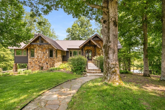 7909 Shoals Branch Rd, Primm Springs, TN 38476 - view of front of house featuring stone siding, a standing seam roof, a front yard, and a metal roof