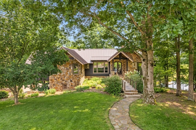 7909 Shoals Branch Rd, Primm Springs, TN 38476 - view of front of property featuring stone siding, a front yard, a standing seam roof, and a metal roof