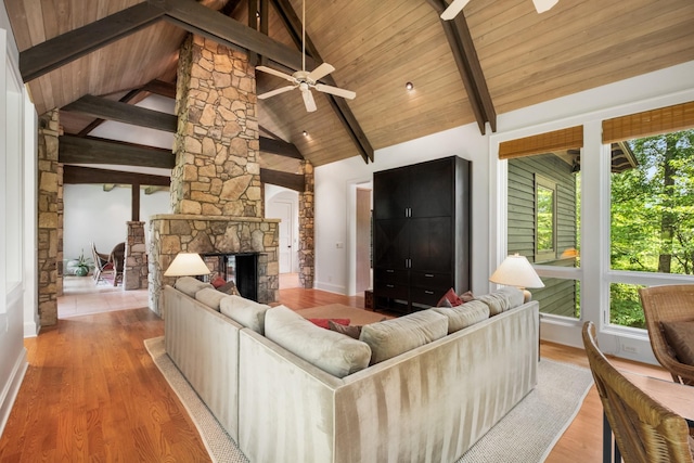 7909 Shoals Branch Rd, Primm Springs, TN 38476 - living room with a ceiling fan, wood finished floors, a stone fireplace, and wood ceiling