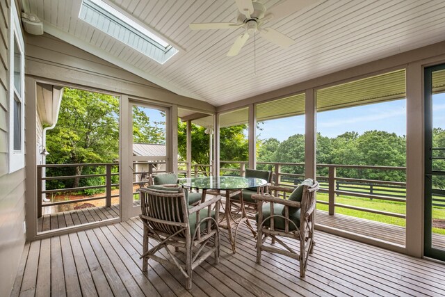 7909 Shoals Branch Rd, Primm Springs, TN 38476 - sunroom / solarium featuring ceiling fan, a skylight, lofted ceiling, view of scattered trees, and outdoor dining space