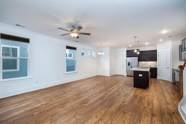 6055 Gracious Dr, Franklin, TN 37064 - unfurnished living room with a ceiling fan, dark wood-style floors, recessed lighting, and a chandelier