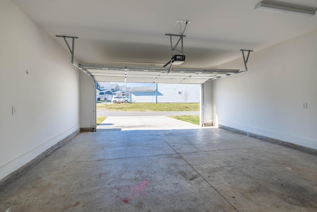 6055 Gracious Dr, Franklin, TN 37064 - garage with a garage door opener and baseboards