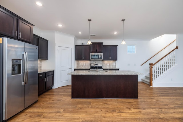 6055 Gracious Dr, Franklin, TN 37064 - kitchen featuring appliances with stainless steel finishes, decorative backsplash, wood finished floors, dark brown cabinets, and recessed lighting