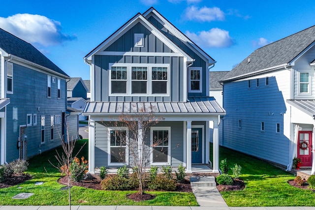 6055 Gracious Dr, Franklin, TN 37064 - view of front of house featuring a porch, board and batten siding, a standing seam roof, a front lawn, and a metal roof
