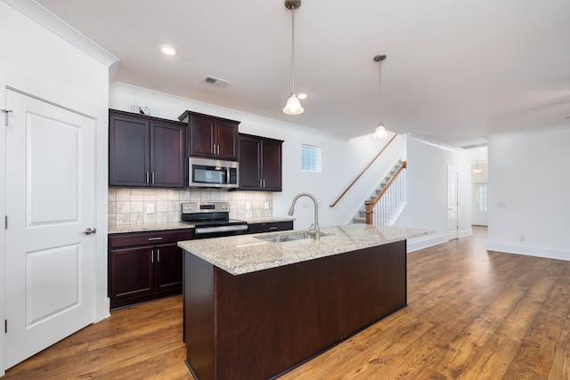 6055 Gracious Dr, Franklin, TN 37064 - kitchen with stainless steel appliances, tasteful backsplash, ornamental molding, dark wood finished floors, and hanging light fixtures