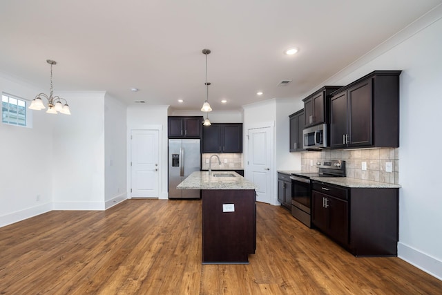 6055 Gracious Dr, Franklin, TN 37064 - kitchen with stainless steel appliances, crown molding, light stone counters, decorative backsplash, and a chandelier