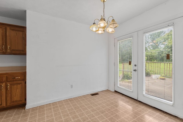 772 Blakemore Rd, Dickson, TN 37055 - unfurnished dining area with french doors, a chandelier, and light flooring
