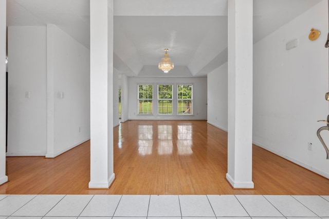 772 Blakemore Rd, Dickson, TN 37055 - unfurnished living room with light wood-style flooring, decorative columns, a chandelier, and lofted ceiling
