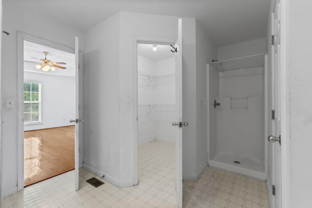 772 Blakemore Rd, Dickson, TN 37055 - bathroom featuring a stall shower, tile patterned floors, a walk in closet, and a ceiling fan