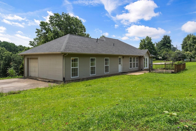 772 Blakemore Rd, Dickson, TN 37055 - rear view of house featuring a garage, driveway, a shingled roof, and a lawn