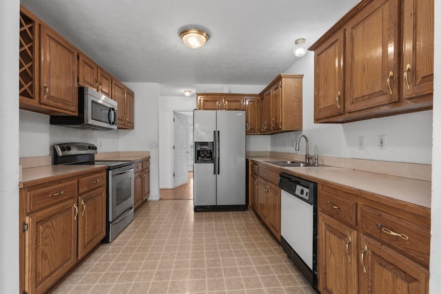 772 Blakemore Rd, Dickson, TN 37055 - kitchen featuring stainless steel appliances, brown cabinets, light flooring, and light countertops