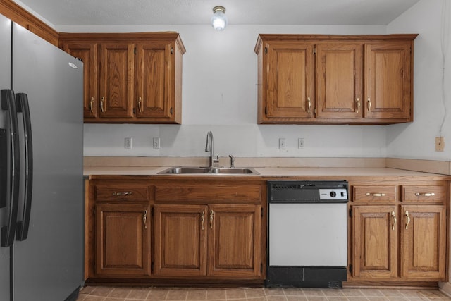 772 Blakemore Rd, Dickson, TN 37055 - kitchen with stainless steel fridge, white dishwasher, brown cabinets, and light countertops