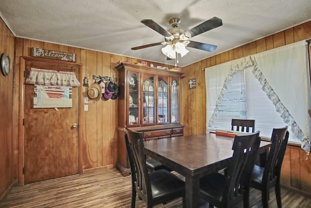 117 Hill Rd, Ardmore, TN 38449 - dining room with ceiling fan, a textured ceiling, wood finished floors, and wooden walls