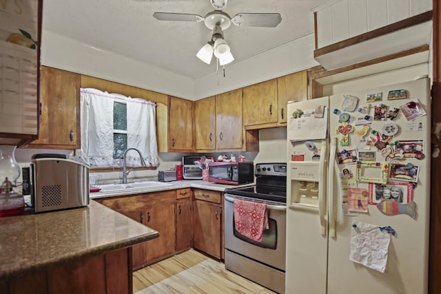 117 Hill Rd, Ardmore, TN 38449 - kitchen featuring white fridge with ice dispenser, stainless steel range with electric stovetop, black microwave, and brown cabinetry