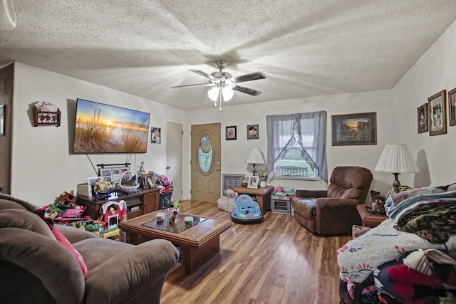 117 Hill Rd, Ardmore, TN 38449 - living area featuring wood finished floors, a ceiling fan, and a textured ceiling