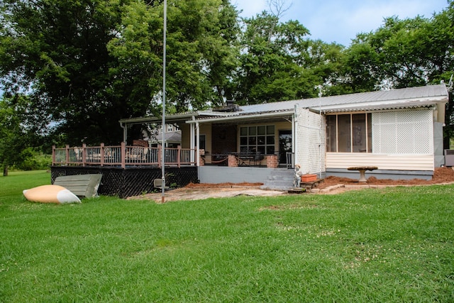 4295 Cairo Bend Rd, Lebanon, TN 37087 - rear view of house with a yard, a metal roof, a wooden deck, and a sunroom