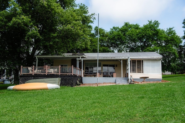 4295 Cairo Bend Rd, Lebanon, TN 37087 - rear view of house featuring a yard, a metal roof, a wooden deck, and a sunroom