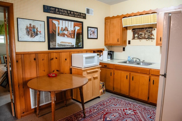 4295 Cairo Bend Rd, Lebanon, TN 37087 - kitchen with white appliances, wallpapered walls, light countertops, brown cabinets, and a wainscoted wall