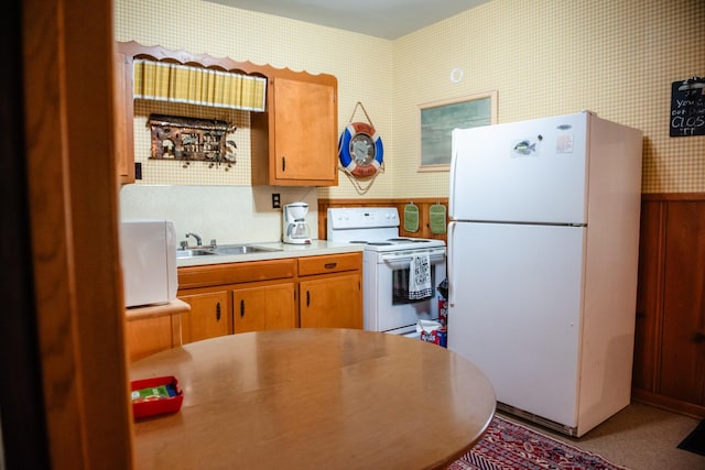 4295 Cairo Bend Rd, Lebanon, TN 37087 - kitchen with white appliances, wallpapered walls, light countertops, wainscoting, and brown cabinetry