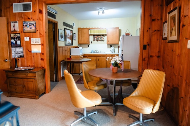 4295 Cairo Bend Rd, Lebanon, TN 37087 - carpeted dining area with a sink and wooden walls