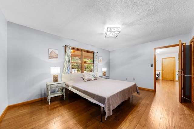 5719 Minor Hill Hwy, Goodspring, TN 38460 - bedroom with light wood-type flooring and a textured ceiling