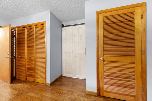 5719 Minor Hill Hwy, Goodspring, TN 38460 - unfurnished bedroom featuring wood-type flooring, a textured ceiling, and a closet