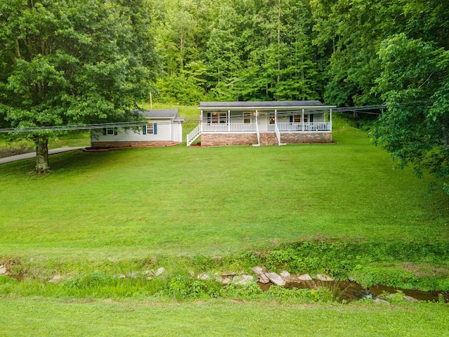 5719 Minor Hill Hwy, Goodspring, TN 38460 - view of front facade with a porch, a front lawn, and a wooded view