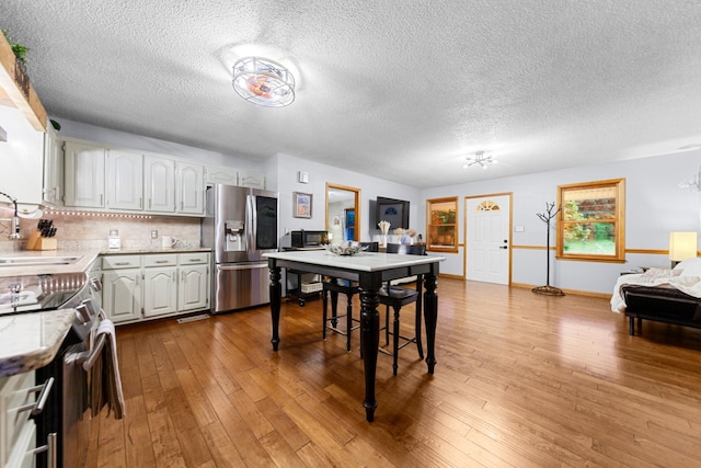 5719 Minor Hill Hwy, Goodspring, TN 38460 - dining room with wood-type flooring and a textured ceiling