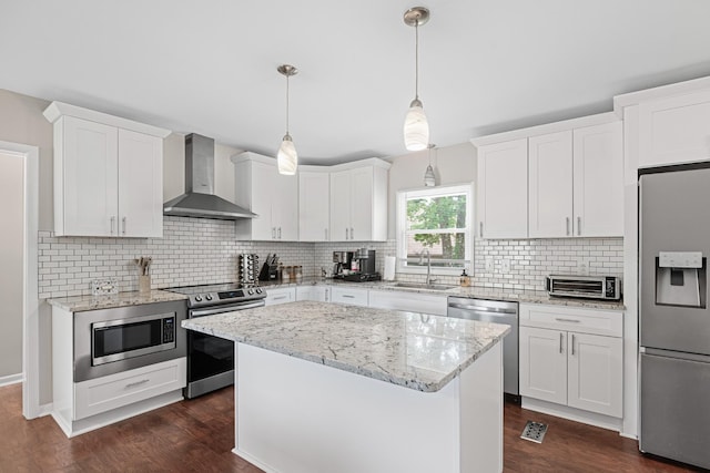 418 Winfrey Dr, Murfreesboro, TN 37130 - kitchen featuring appliances with stainless steel finishes, wall chimney exhaust hood, dark wood-type flooring, and white cabinets