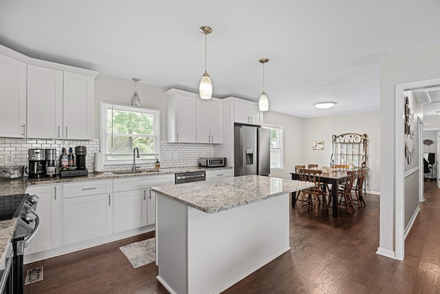 418 Winfrey Dr, Murfreesboro, TN 37130 - kitchen with stainless steel appliances, decorative backsplash, dark wood finished floors, white cabinets, and light stone counters