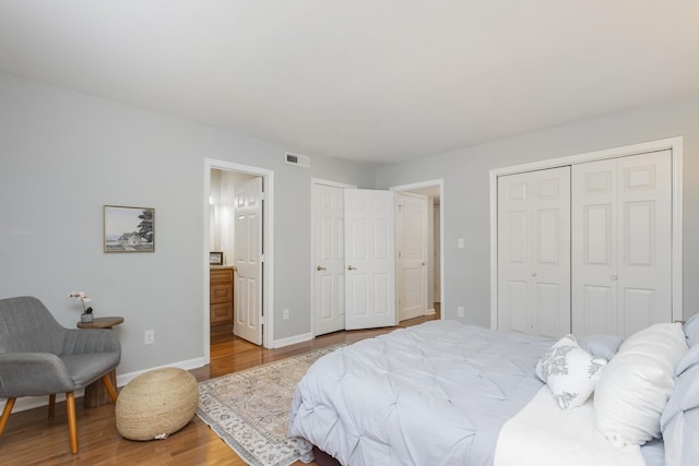 217 Ellington Pl, Madison, TN 37115 - bedroom featuring wood finished floors, two closets, and ensuite bath