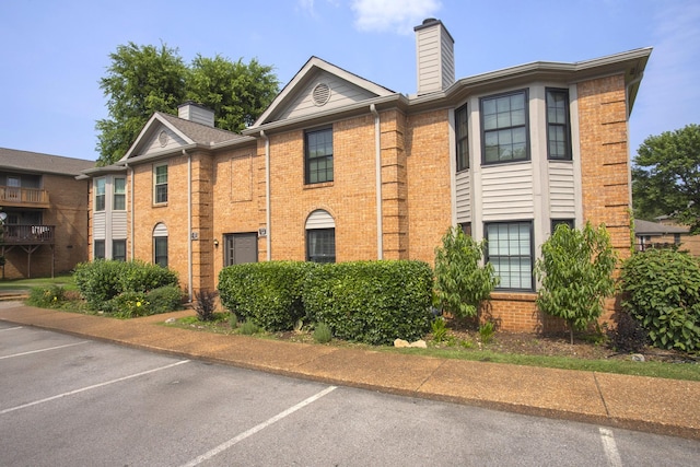 217 Ellington Pl, Madison, TN 37115 - townhome / multi-family property featuring uncovered parking, a chimney, and brick siding