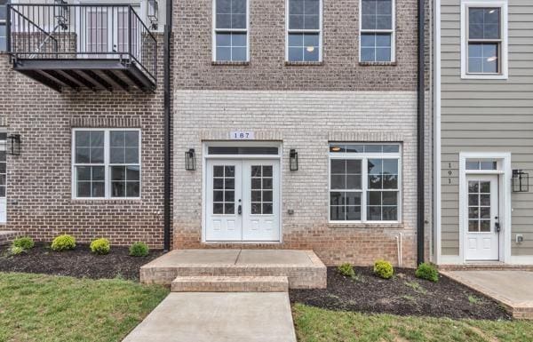 187 Charleston Ave, Pleasant View, TN 37146 - property entrance featuring a balcony, brick siding, and french doors