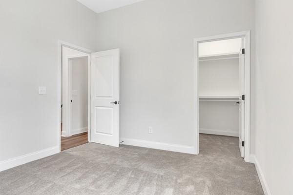 187 Charleston Ave, Pleasant View, TN 37146 - unfurnished bedroom featuring carpet floors, a spacious closet, and a closet