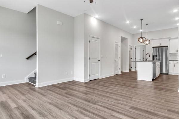 187 Charleston Ave, Pleasant View, TN 37146 - unfurnished living room featuring wood finished floors, recessed lighting, stairs, and ceiling fan
