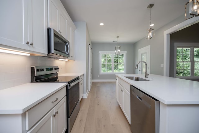 11497 Karo Rd, Bell Buckle, TN 37020 - kitchen with stainless steel appliances, light wood-style floors, recessed lighting, decorative backsplash, and white cabinetry