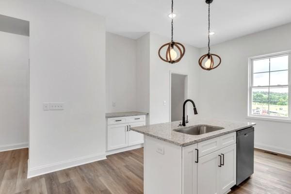 191 Charleston Ave, Pleasant View, TN 37146 - kitchen with stainless steel dishwasher, wood finished floors, light stone countertops, and white cabinets